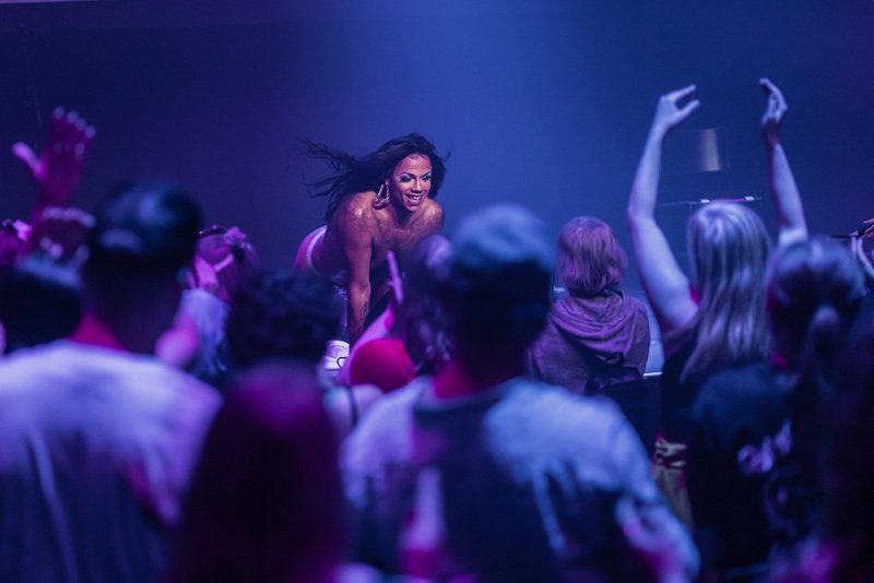 Tina Hyena beams on stage as the crowd goes wild at ANTI Festival in Kuopio, Finland as part of Brownton Abbey the afrofuturistic space church themed performance party celebrating and elevating queer disabled artists of colour.