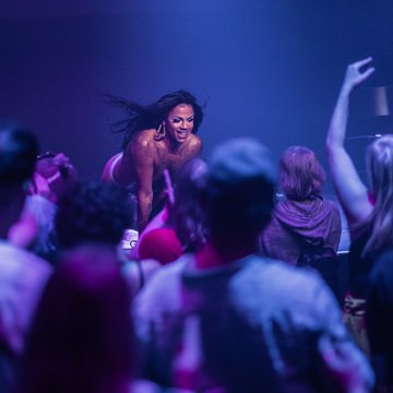 Tina Hyena beams on stage as the crowd goes wild at ANTI Festival in Kuopio, Finland as part of Brownton Abbey the afrofuturistic space church themed performance party celebrating and elevating queer disabled artists of colour.